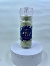 Load image into Gallery viewer, Handcrafted Lemon Herb Salt grinder by Summa Salts, made in Jacksonville, FL, with visible lemon verbena, garlic scapes, and coarse sea salt.
